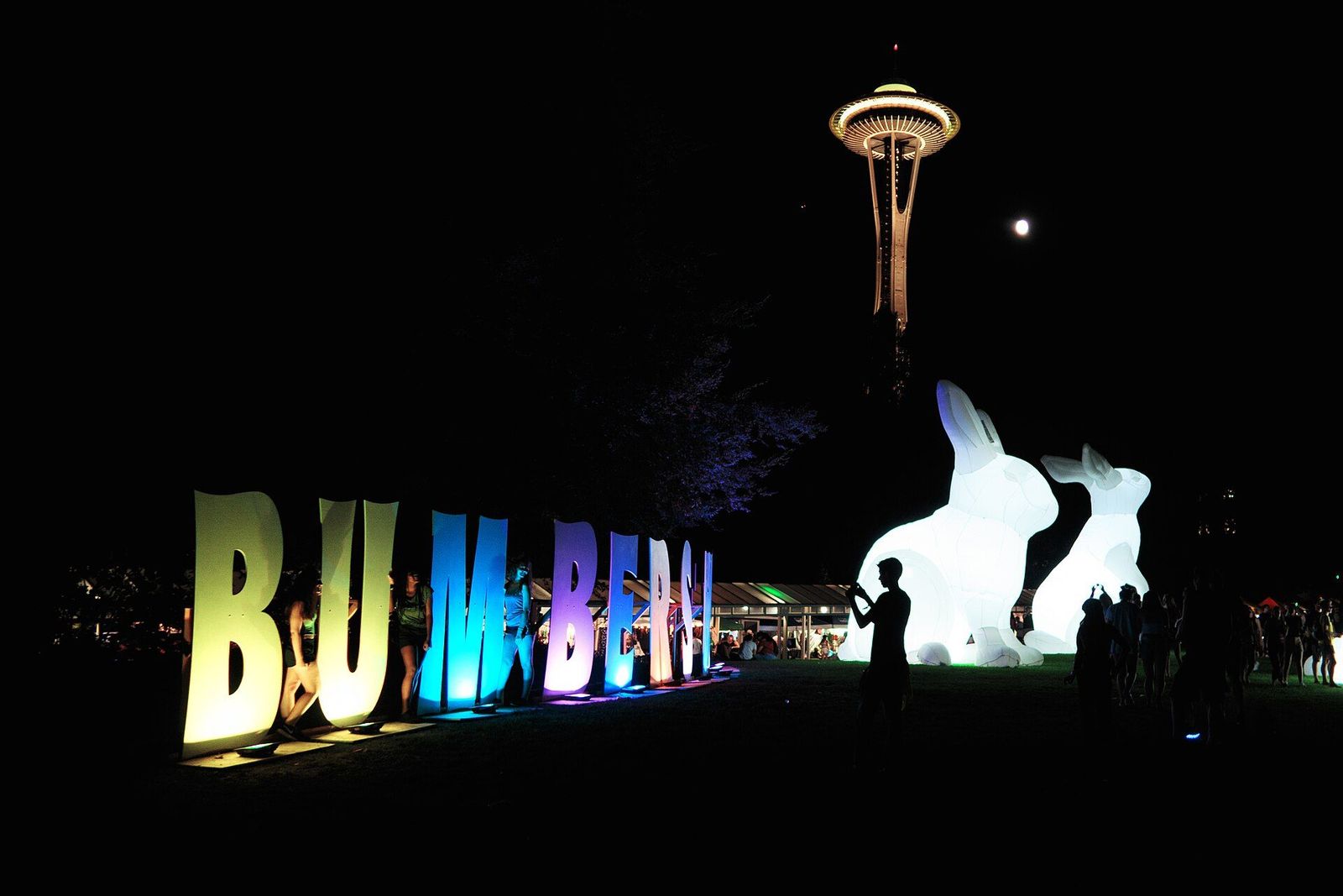 Bumbershoot sign lit at night