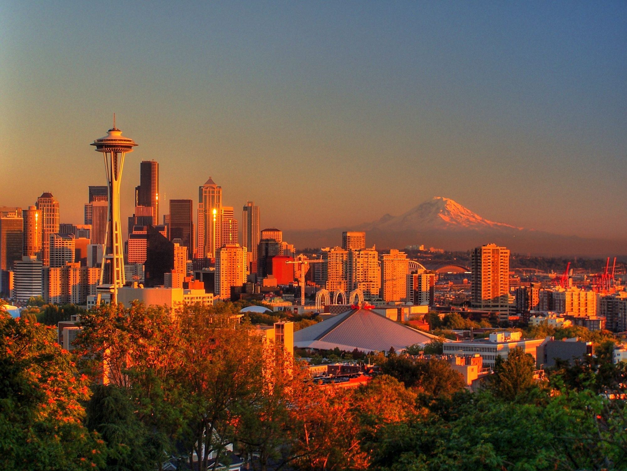Seattle skyline at sunset with Mount Rainier glowing behind